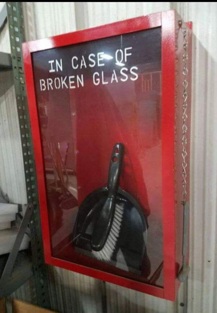 An emergency box labeled in case of broken glass containing a dustpan, representing funny advertising fails.