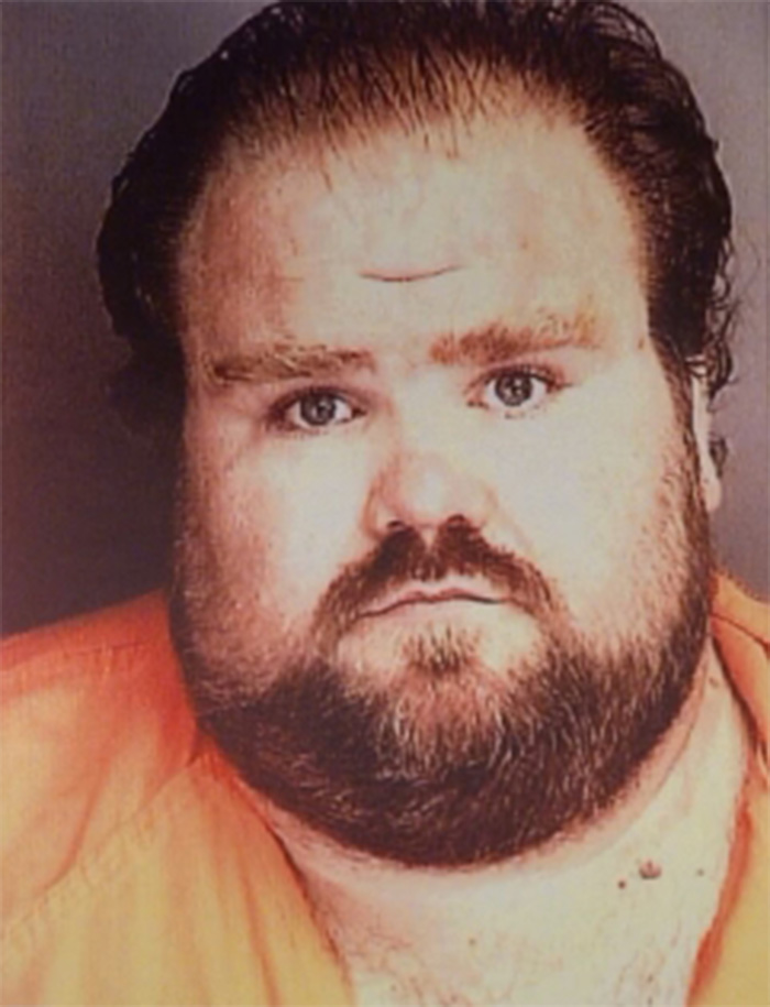 Mugshot of a heavy-set man with a beard, a convict who survived lethal injection.