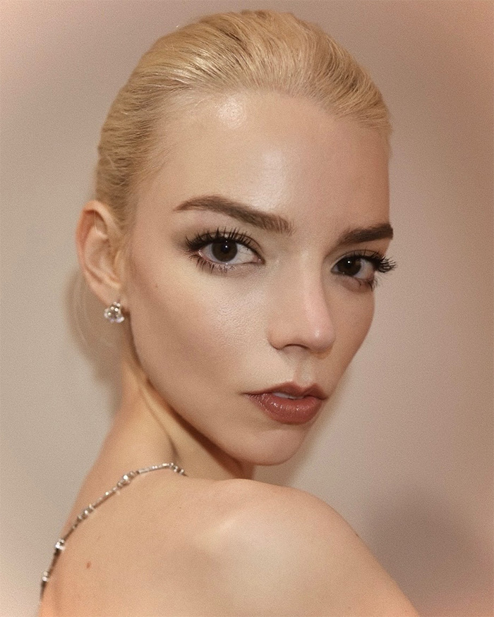 Close-up portrait of Anya Taylor-Joy highlighting plastic surgery trends in cheek definition. Close-up portrait of Anya Taylor-Joy highlighting plastic surgery trends in cheek definition.