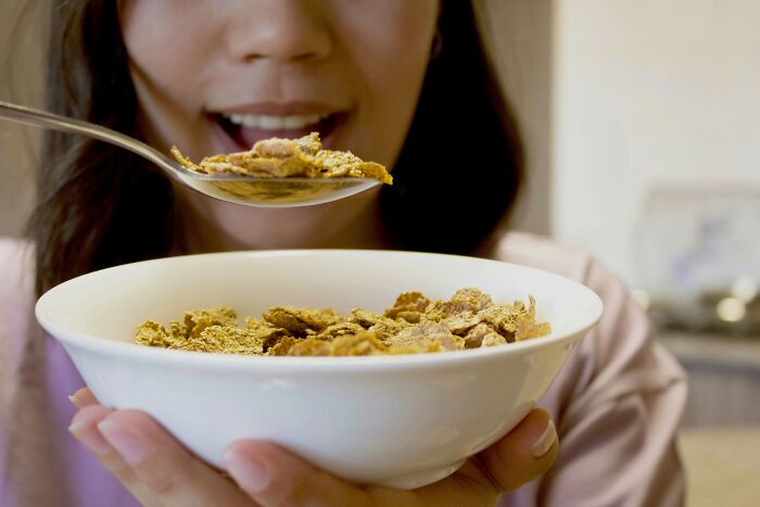 A woman eating a bowl of cereal, highlighting historic PR stunts in food marketing.