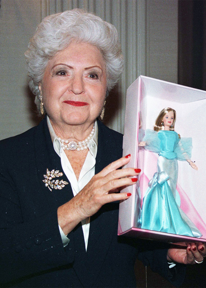 Ruth Handler holding a vintage boxed Barbie doll associated with the Mattel brand.