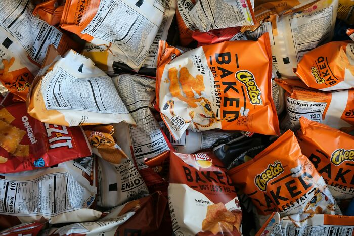 Pile of baked Cheetos snack bags showing nutrition labels