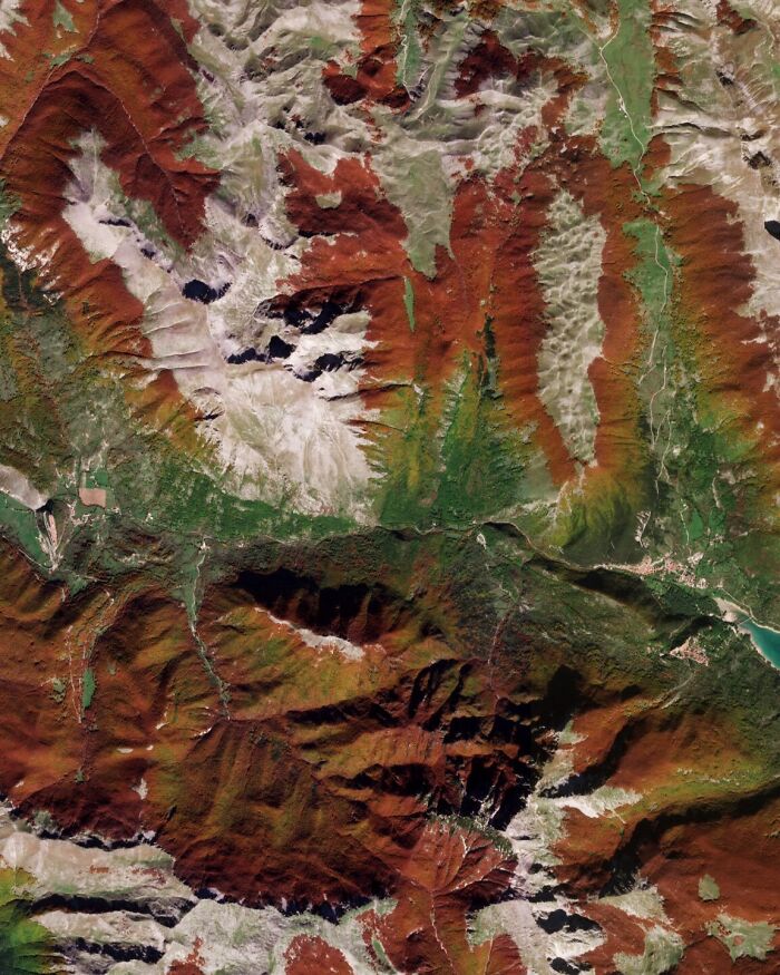 Satellite photos showing a surreal overhead view of reddish mountain peaks and valleys