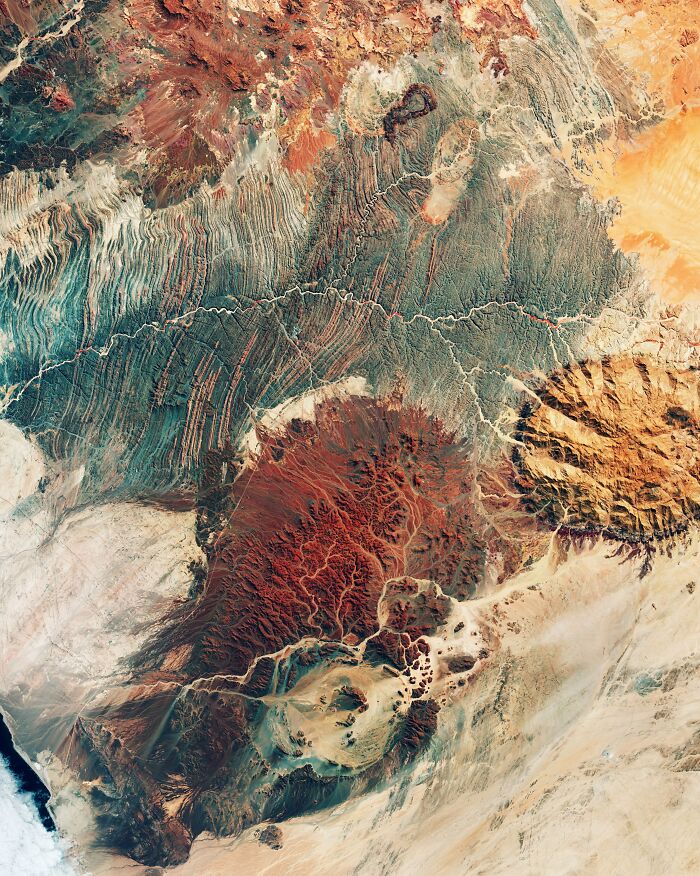 Surreal satellite photos showing colorful red and orange rock formations from above