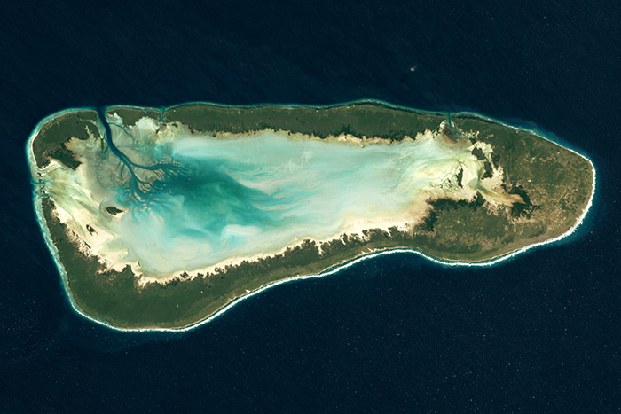 Satellite view of Aldabra Atoll showing the turquoise lagoon and green land