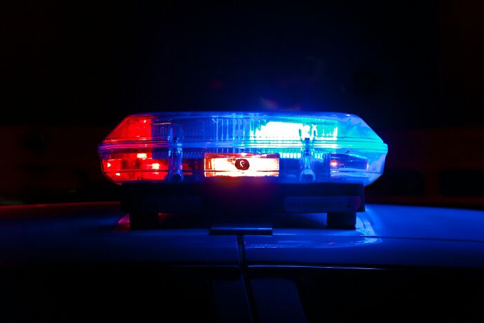 Flashing red and blue police emergency lights representing cruel infidelity stories.