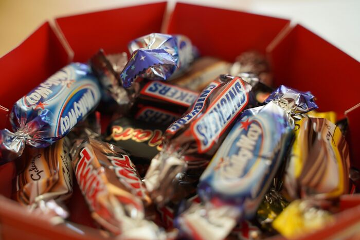 An assortment of sweet candies in a container for Halloween treats.