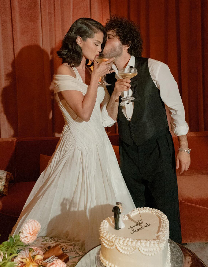 Selena Gomez and Benny Blanco kissing with champagne and a cake on the table Selena Gomez and Benny Blanco kissing with champagne and a cake on the table