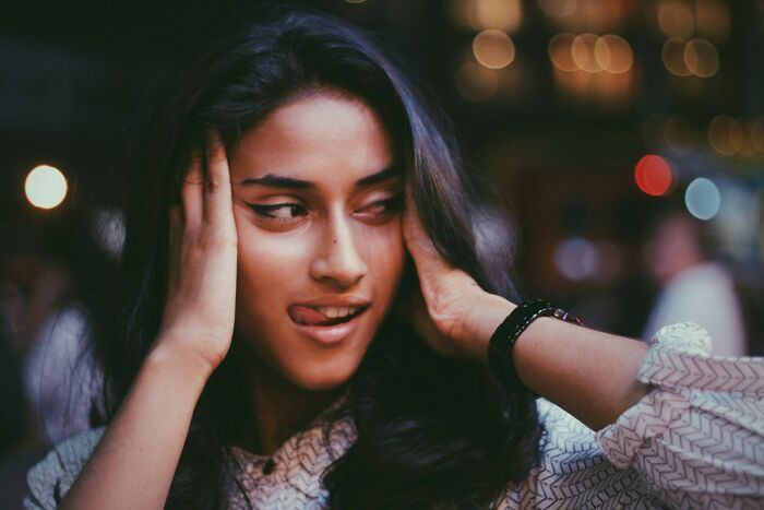 A close-up of a young woman sticking her tongue out, showcasing behaviors they refuse to tolerate.