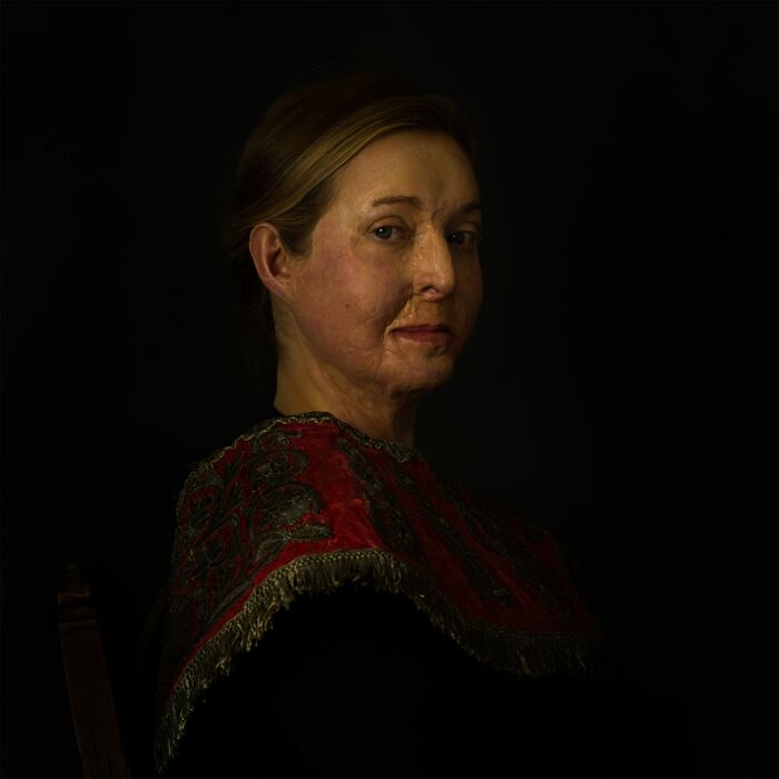 Portrait of woman with facial scars in dark setting, best pics Siena International Photo Awards 2026