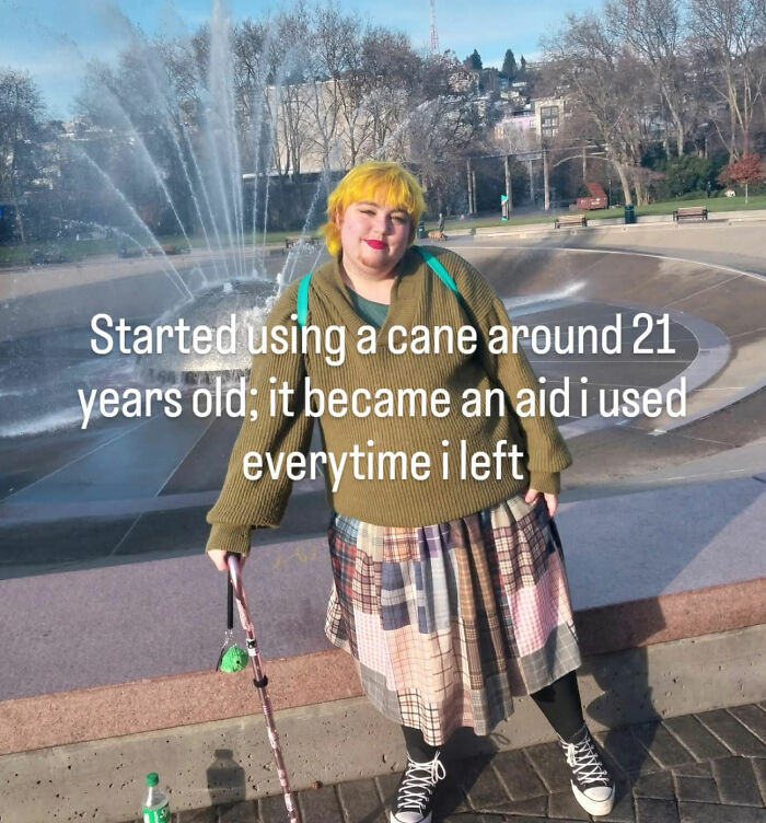 Young person with a cane posing near a fountain, representing young women using mobility aids
