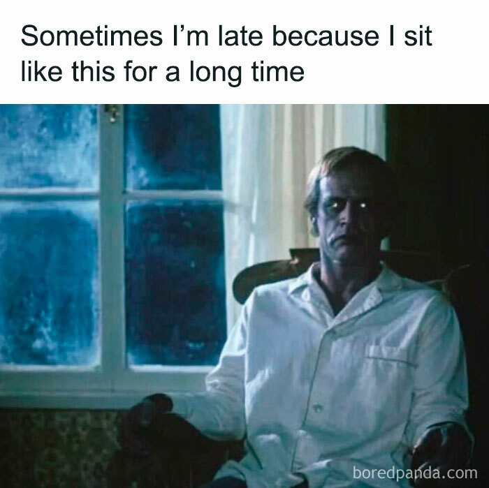 Spooky season meme featuring a creepy man sitting in a dark room staring blankly out the window.