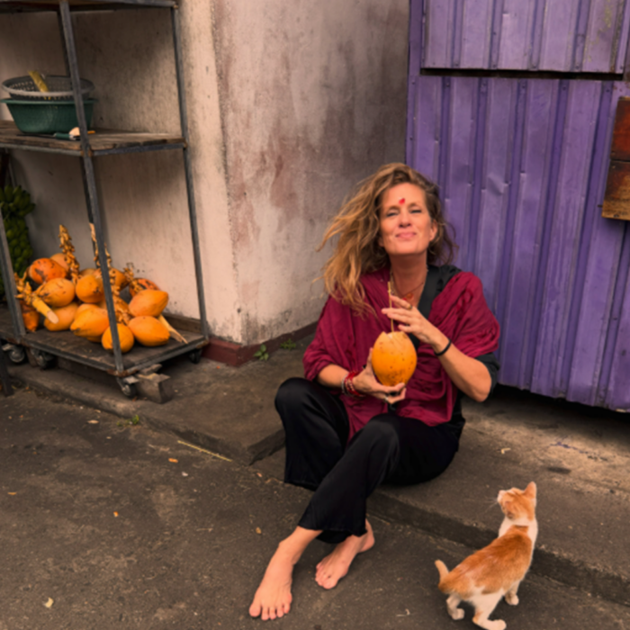 The Stacy's Mom star sitting outdoors holding a coconut drink, showing how millennials view her iconic role today. The Stacy's Mom star sitting outdoors holding a coconut drink, showing how millennials view her iconic role today.