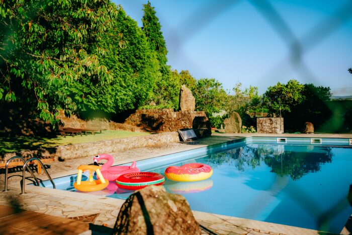 A sunny swimming pool with colorful floats, evocative of the iconic Stacy's Mom music video setting. A sunny swimming pool with colorful floats, evocative of the iconic Stacy's Mom music video setting.