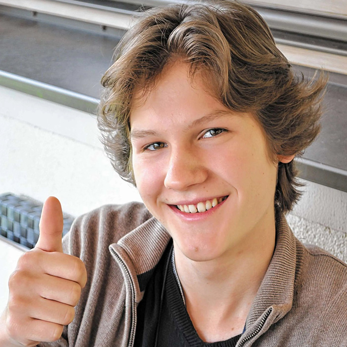 A young man giving a thumbs-up gesture, representing a popular video game creator.