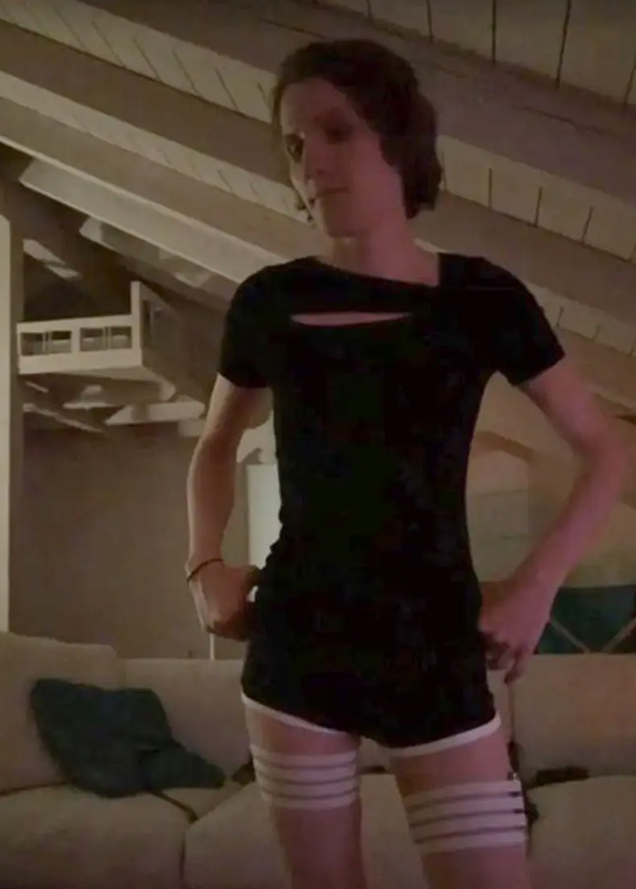 A person in dark attire indoors during a livestream event.