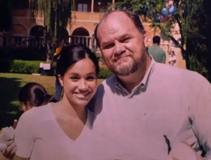 Young Meghan Markle smiling next to her father Thomas Markle outdoors Young Meghan Markle smiling next to her father Thomas Markle outdoors