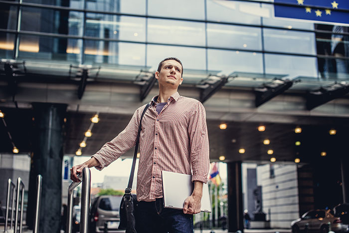 A worried traveler standing outside an airport terminal, representing travelers stopped by TSA