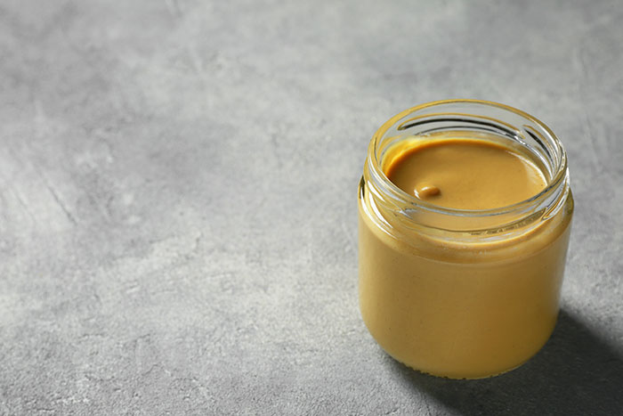 An open glass jar of peanut butter, a common liquid-like item that can get travelers stopped by TSA.