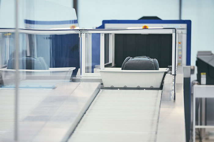 Baggage on a security conveyor belt, showing items scanned that might get travelers stopped by TSA.