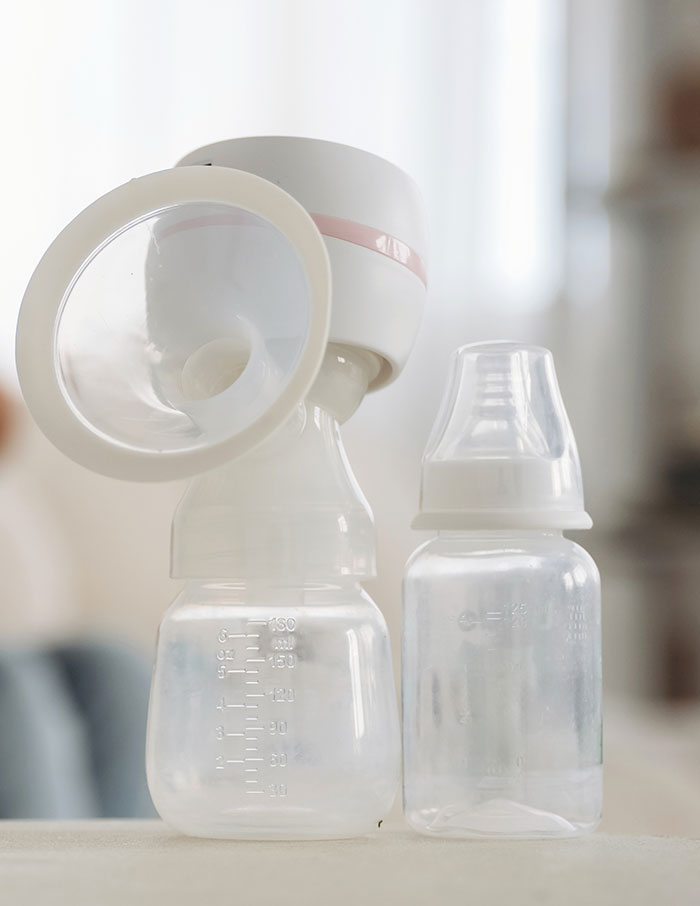 A breast pump and baby bottle on a table, which can surprise travelers stopped by TSA