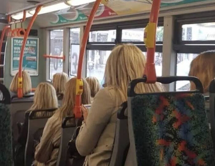Bus interior with multiple identical blonde women glitch matrix