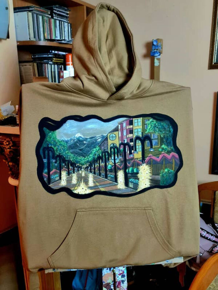 Hoodie with painted perspective glitch showing a distorted street scene
