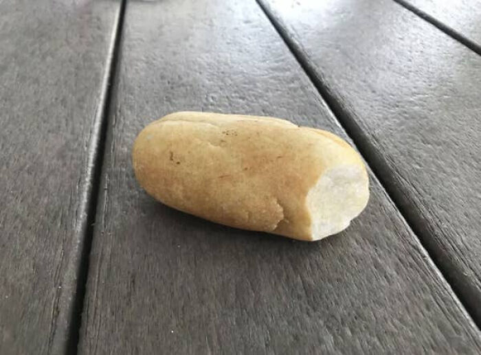 Object resembling bread placed on wooden floor glitch in the matrix