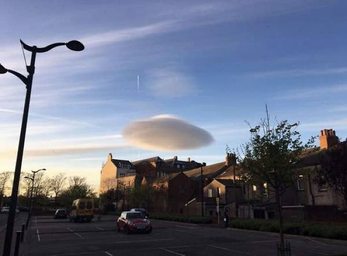 Unusual lenticular cloud over a town glitch in the matrix