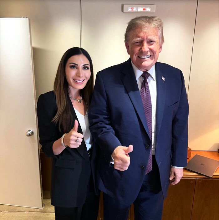Laura Loomer posing next to Donald Trump, both giving a thumbs up, related to the MAGA Face trend discussion. Laura Loomer posing next to Donald Trump, both giving a thumbs up, related to the MAGA Face trend discussion.