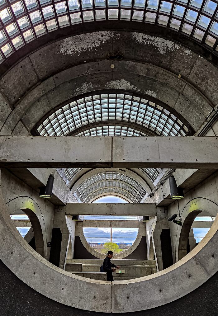 A person walking through a concrete tunnel with geometric patterns, featured in The Perspa Awards 2026.