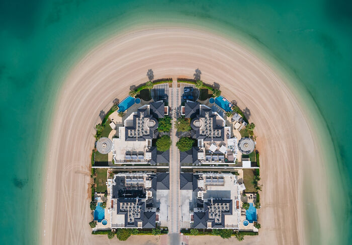 Aerial view showing the hidden beauty of buildings and spaces on a sandy crescent