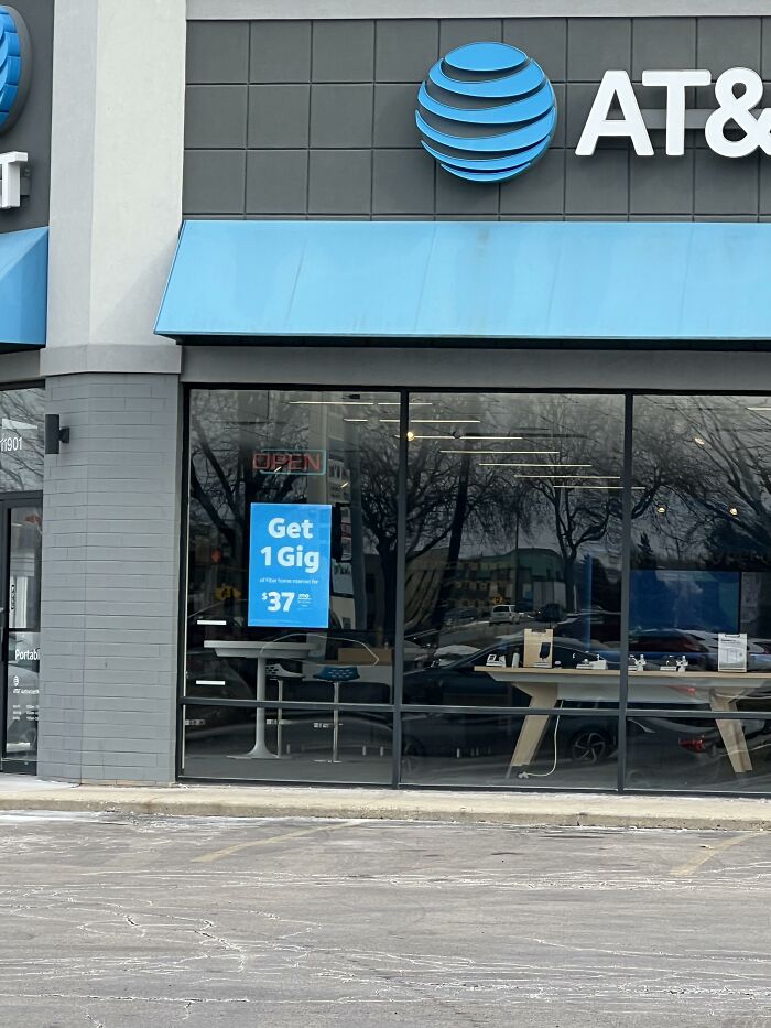 AT&T store front with an internet deal advertisement displaying an ad design mistake.