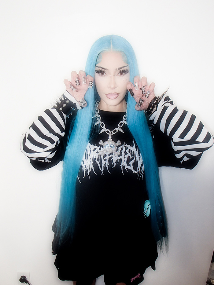 Woman with bright blue hair dressed up for celebrity Halloween costumes