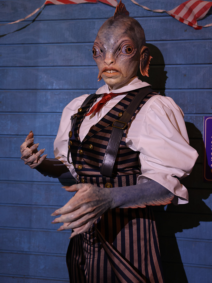 Detailed fish creature prosthetic dress in stripe suit as a celebrity Halloween costume