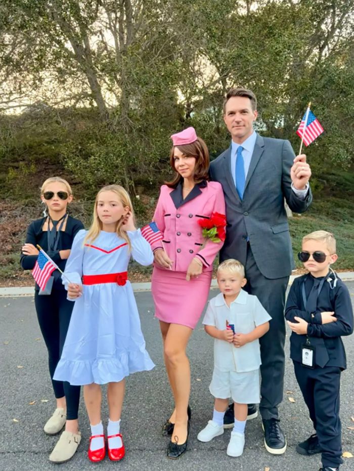 A family posing in JFK and Jackie Kennedy themed celebrity Halloween costumes