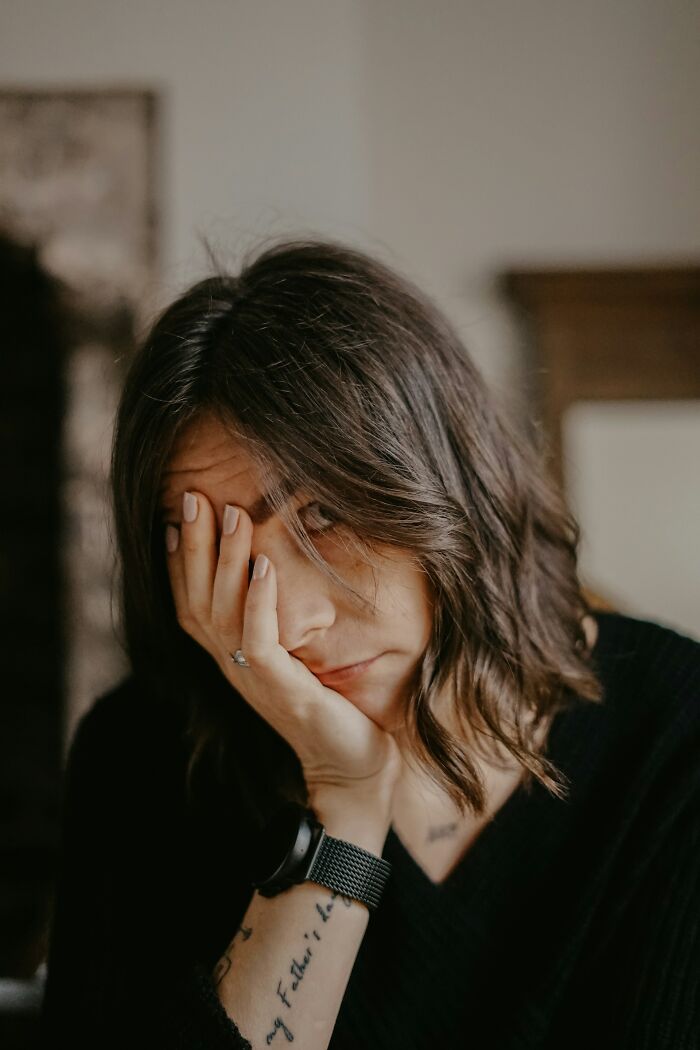 A woman facepalming over embarrassing fails and funny instances in daily life