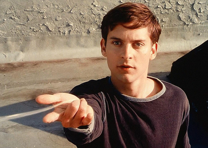 Young Tobey Maguire reaching his hand out, known for Spider-Man. Young Tobey Maguire reaching his hand out, known for Spider-Man.