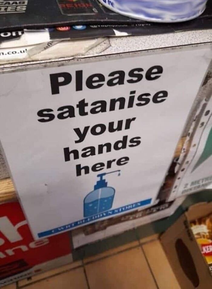 Hand sanitizer station sign with hilarious translation fails asking to Please satanise your hands here.
