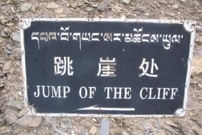 A outdoor sign showcasing funny translation fails with text reading JUMP OF THE CLIFF.