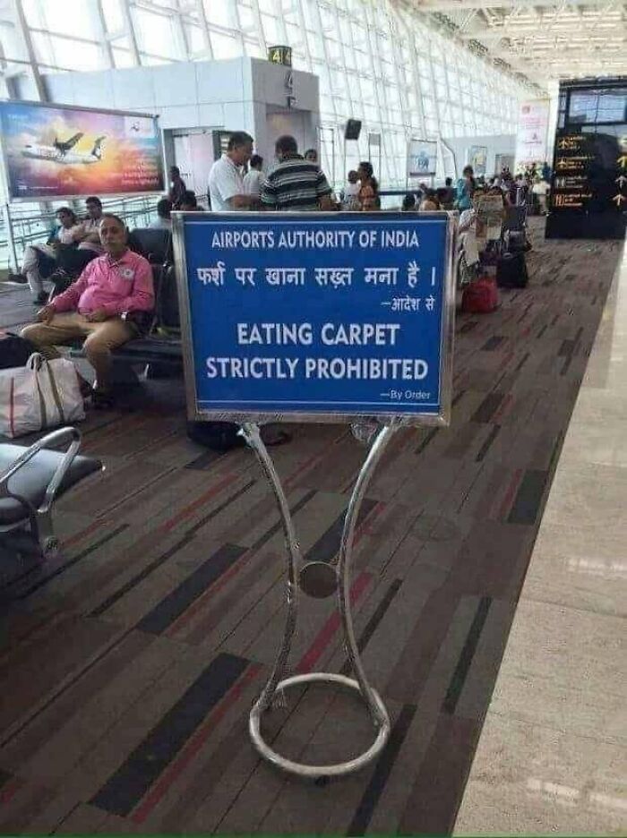Airport sign displaying translation fails with text reading Eating Carpet Strictly Prohibited.