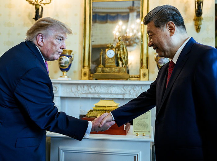 Donald Trump shaking hands with Xi Jinping in a formal room. Donald Trump shaking hands with Xi Jinping in a formal room.