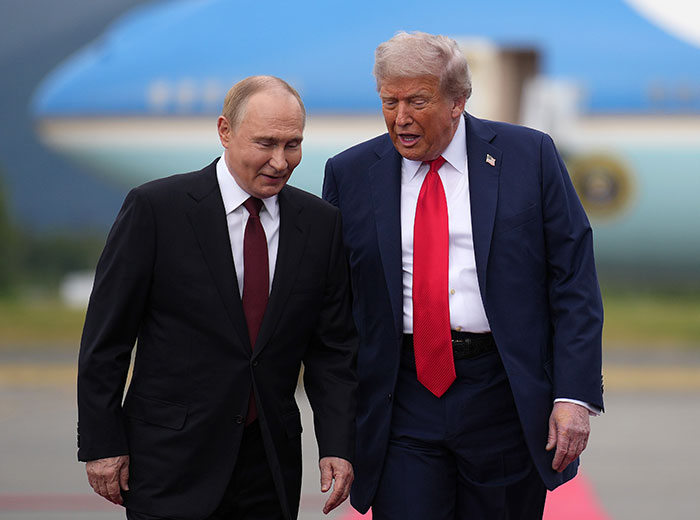 Donald Trump walks with Vladimir Putin near Air Force One, discussing something intently on the runway. Donald Trump walks with Vladimir Putin near Air Force One, discussing something intently on the runway.