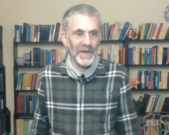 UC Berkeley professor sitting in front of bookshelves while speaking about a troubling trend in homework.