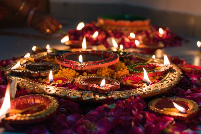 Decorated oil lamps and flowers lit up during festive Halloween celebrations.