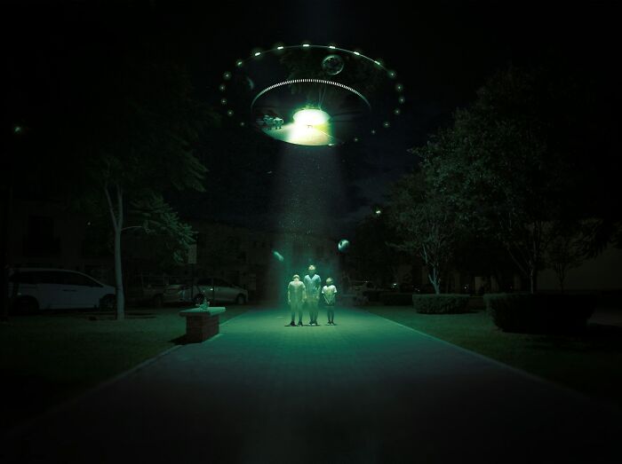 A glowing UFO above people at night, illustrating true stories that sound unbelievable.