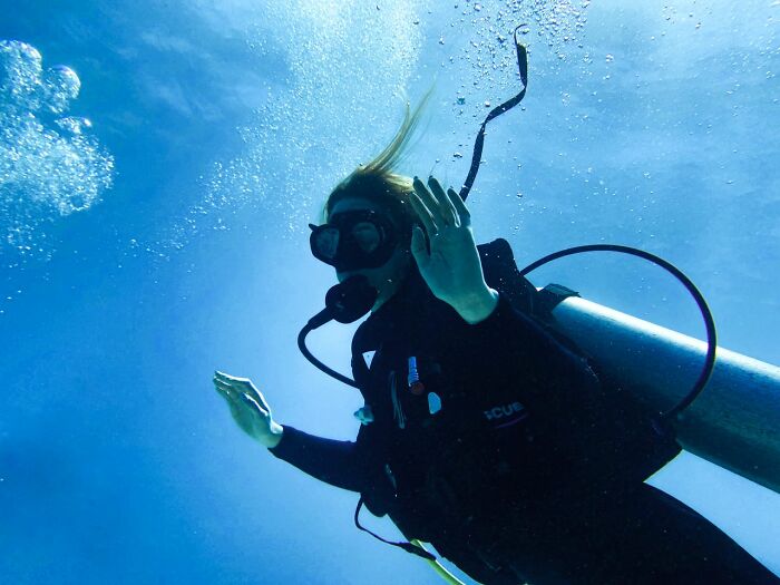 A scuba diver underwater with air bubbles floating up, illustrating true stories shared by people.