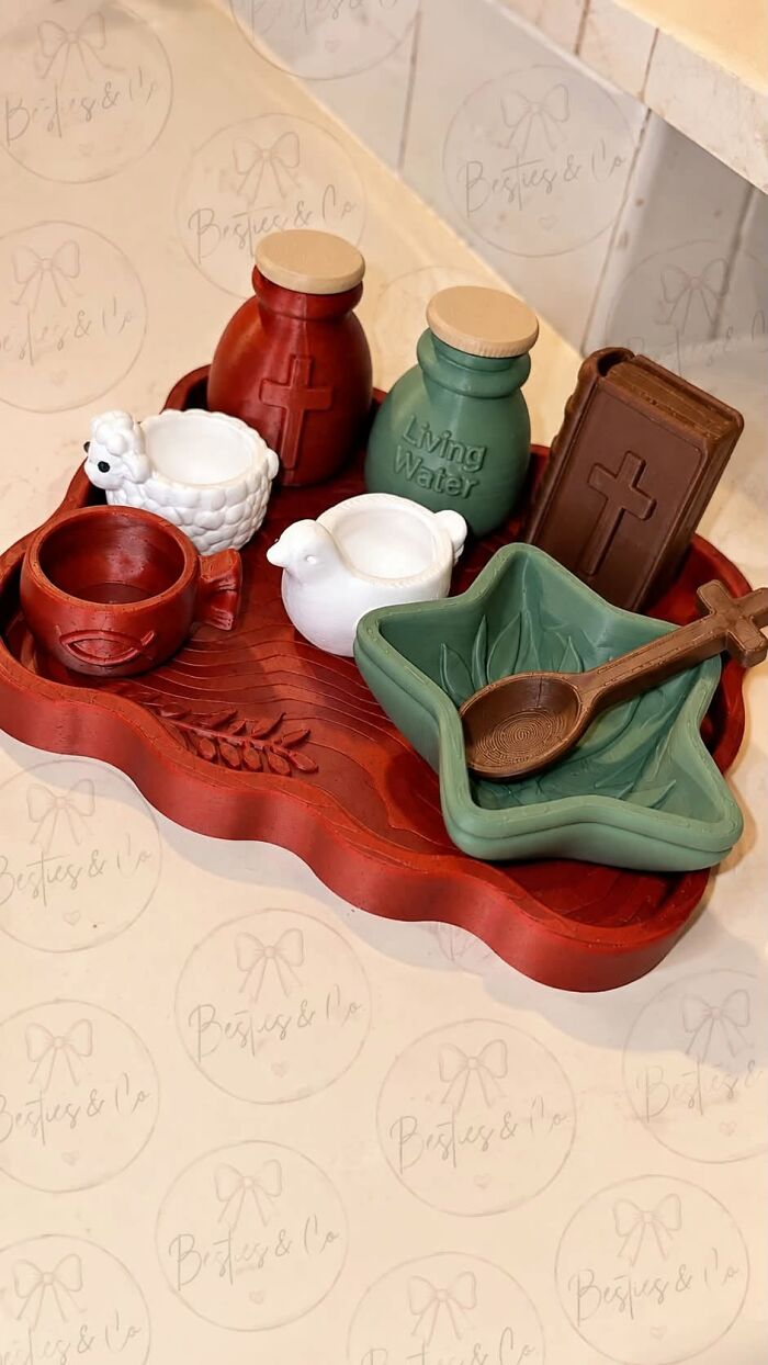 An array of 3D printed religious toys on a red tray, showing the potential of a 3D printer.