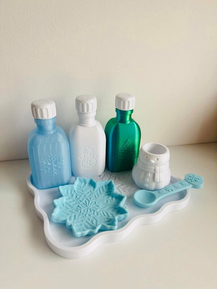 Colorful winter-themed plastic bottles and cups made with a 3D printer