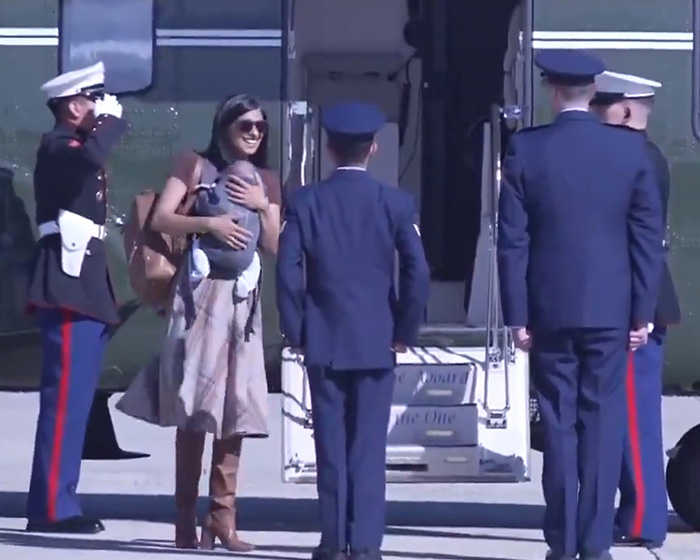 Second Lady Usha Vance smiling as she walks down the stairs carrying her baby. Second Lady Usha Vance smiling as she walks down the stairs carrying her baby.